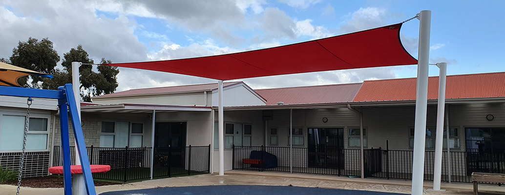Red and white sails above the Northern Support School outdoor area